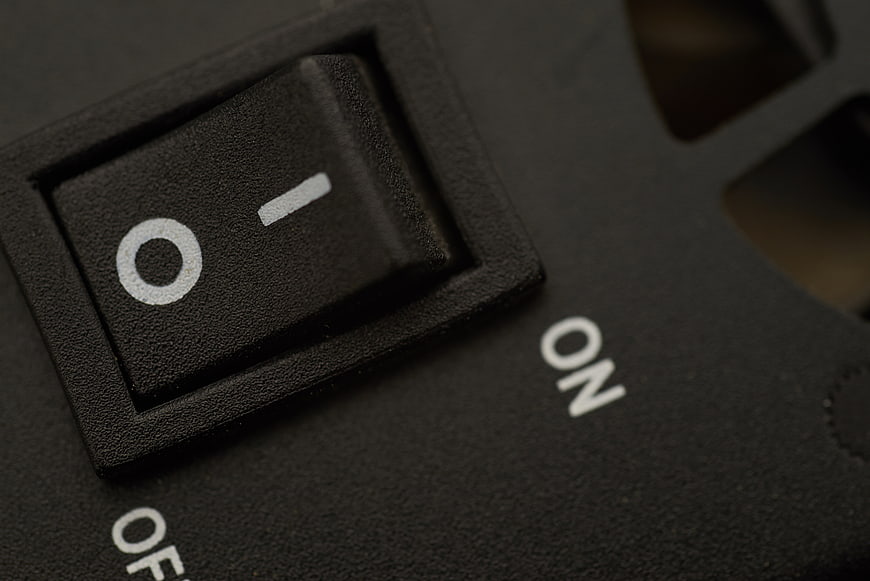 Close-up of black rocker power switch in off position