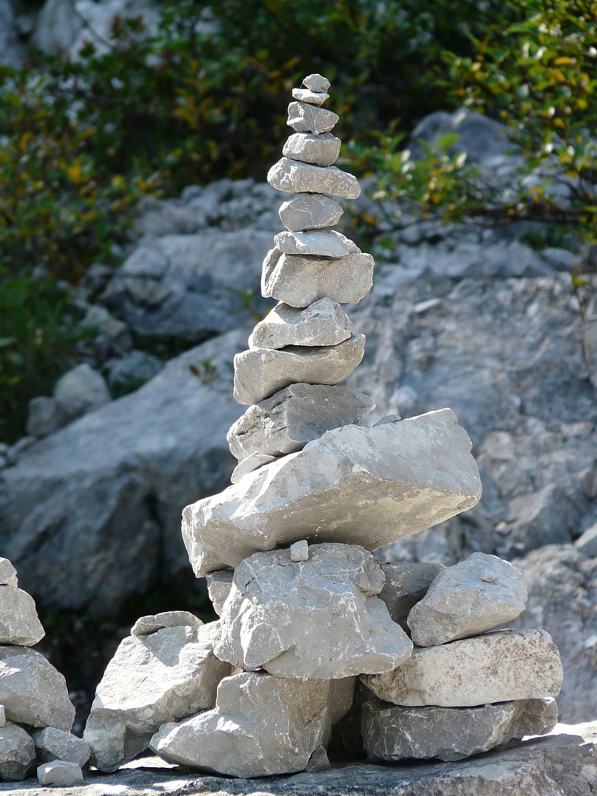 Stacked Stone Cairn Tower in Rocky Mountain Landscape