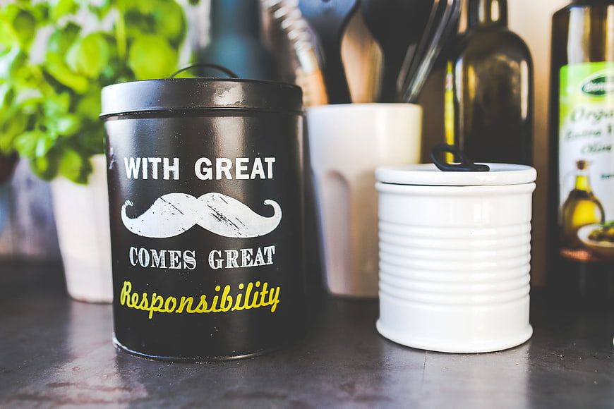 Black kitchen canister with mustache quote and white jar