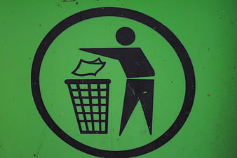 Green trash bin with black disposal symbol