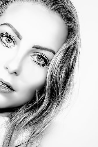 Black and white close-up portrait of a young woman with detailed eyes