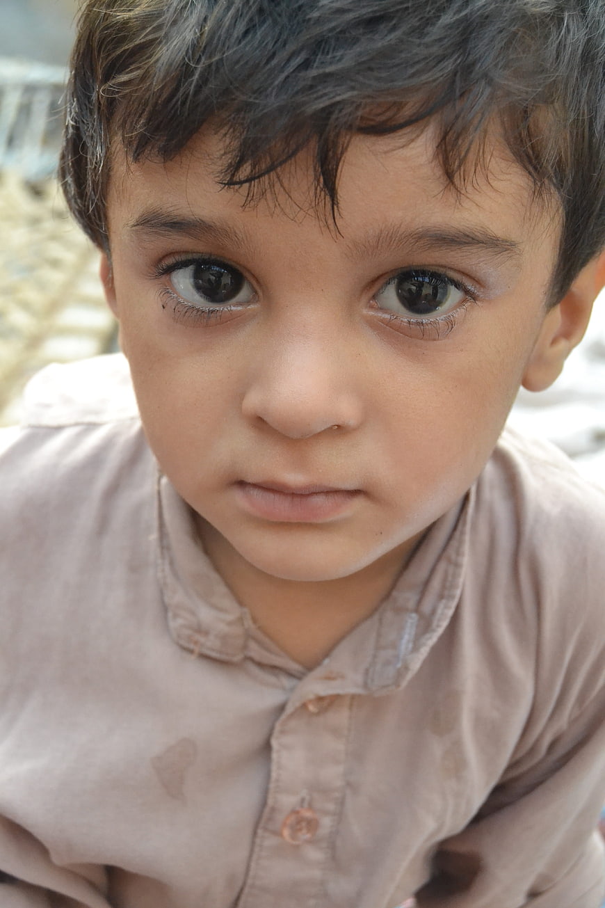 Close-up portrait of a young boy with intense eyes