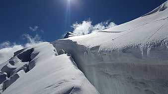 Snowy Mountain Ridge with Deep Crevasse and Blue Sky