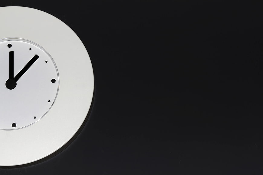 Minimalist White Clock on Black Background with Copyspace