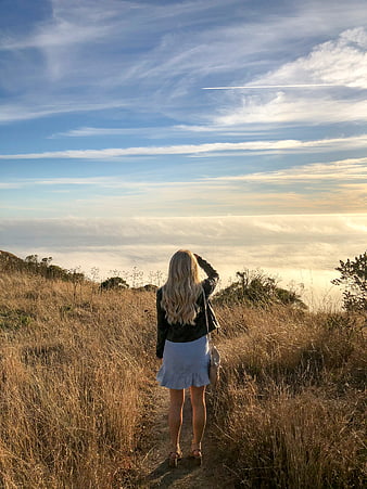 Woman Looking at Sea of Clouds from Mountain Trail