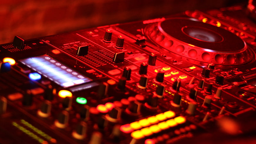 DJ Mixer Controller Illuminated In Red Light