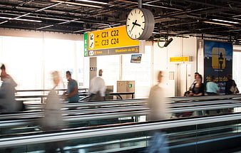Motion blur of travelers on airport moving walkway