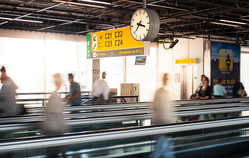 Motion blur of travelers on airport moving walkway