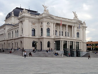 Grand White Neoclassical Building with Statues and Plaza
