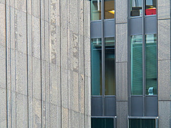 Modern building facade with stone cladding and glass windows