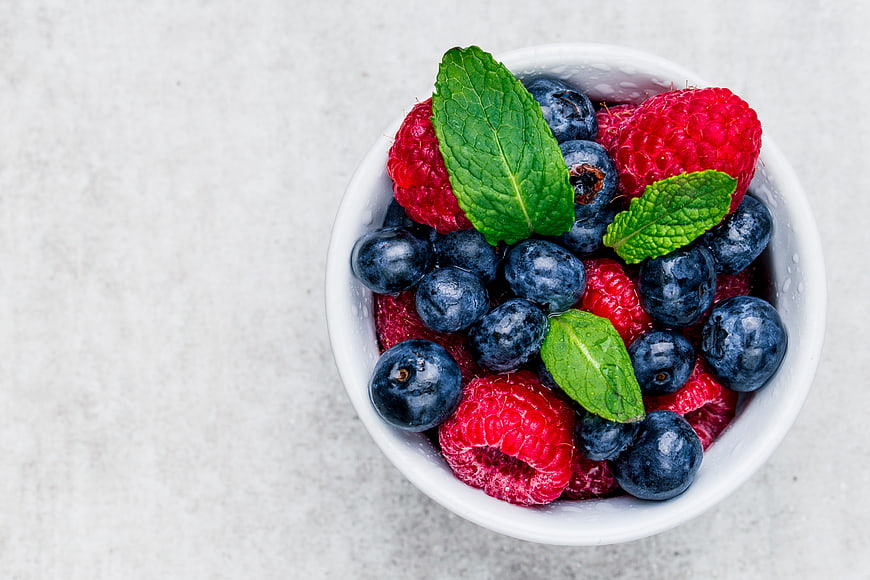 Top View of Fresh Blueberries and Raspberries in White Bowl