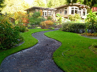 Winding Garden Path Leading To A Lush Residential Home