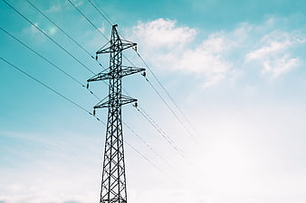 High Voltage Power Tower Against Blue Sky