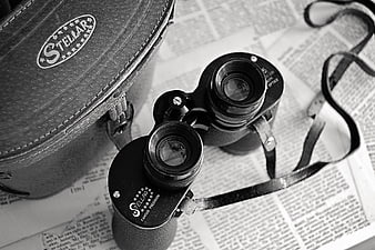 Vintage Stellar Binoculars on Newspaper
