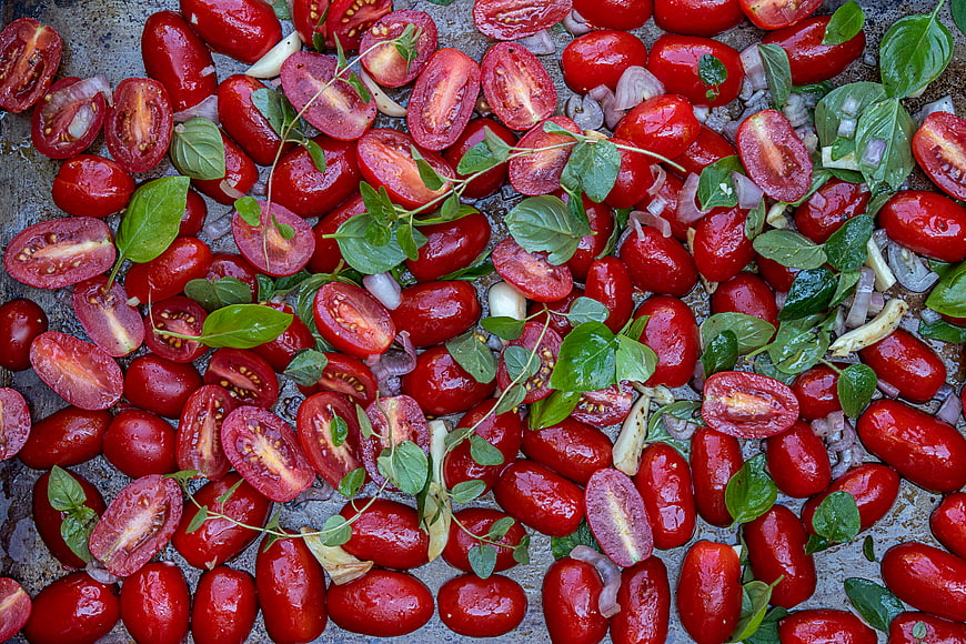 Roasted Cherry Tomatoes with Basil and Garlic on Baking Sheet