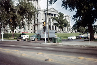 Vintage street scene with classic cars and government building