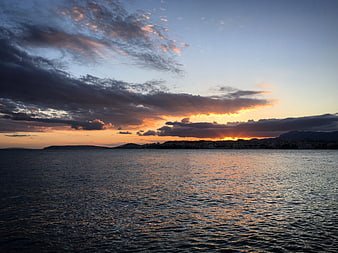 Dramatic Sunset Over Coastal City and Ocean