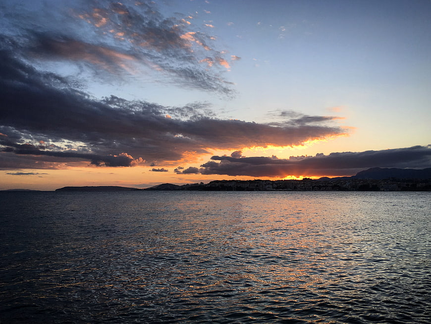 Dramatic Sunset Over Coastal City and Ocean
