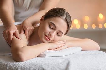 Relaxed Woman Receiving Shoulder Massage at Spa