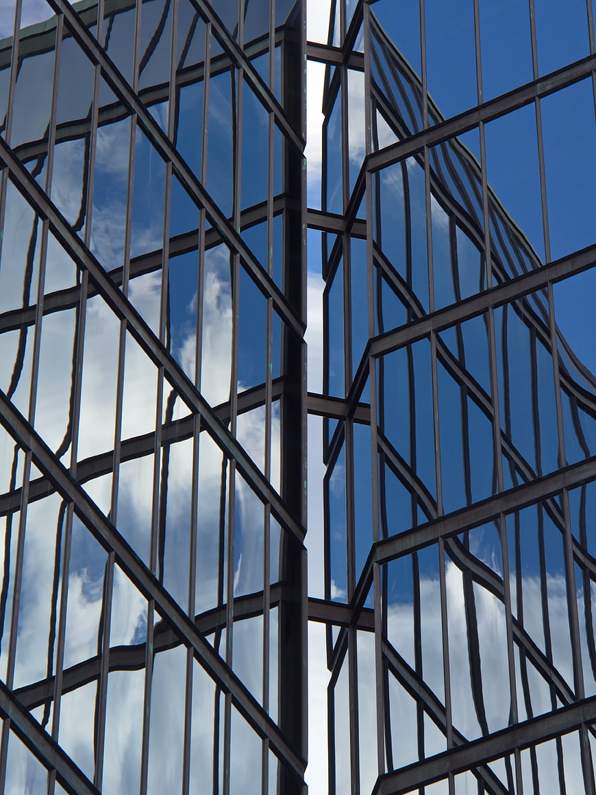 Abstract Reflection of Blue Sky on Modern Glass Building Facade