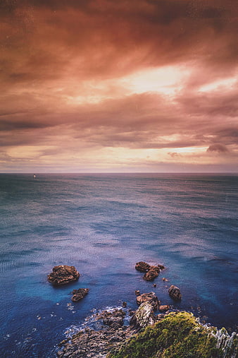 Dramatic Sunset Over Rocky Ocean Coastline