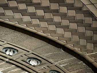 Abstract architectural ceiling detail with textured brick pattern and lights