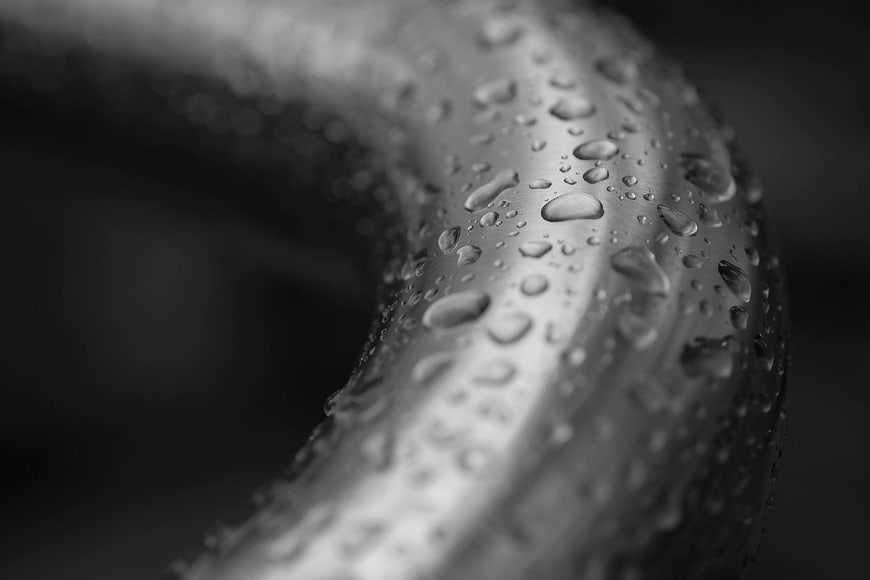 Macro black and white water droplets on curved surface