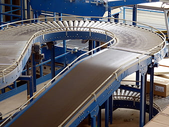 Curved industrial conveyor belt system in warehouse