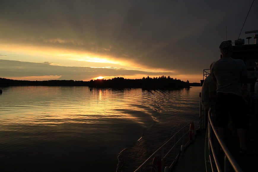 Silhouette of People Watching Sunset from Boat Deck