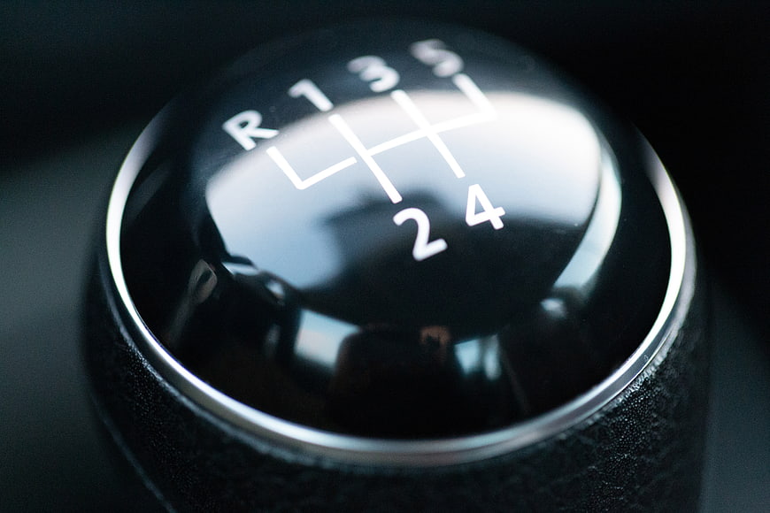 Close-up of a black manual car gear shift knob
