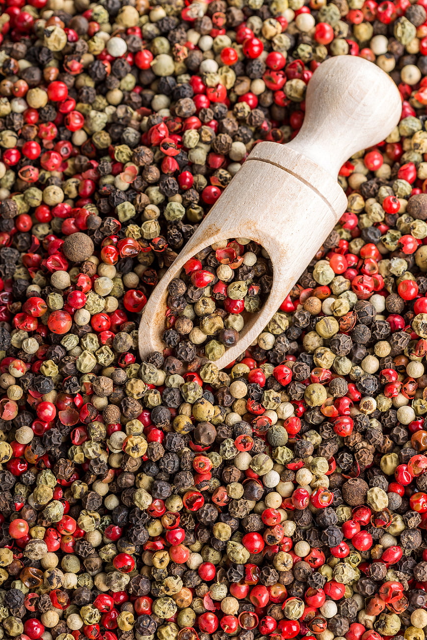 Wooden Scoop with Mixed Color Peppercorns Top View