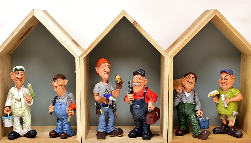 Caricature Construction Worker Figurines in Wooden House Frames