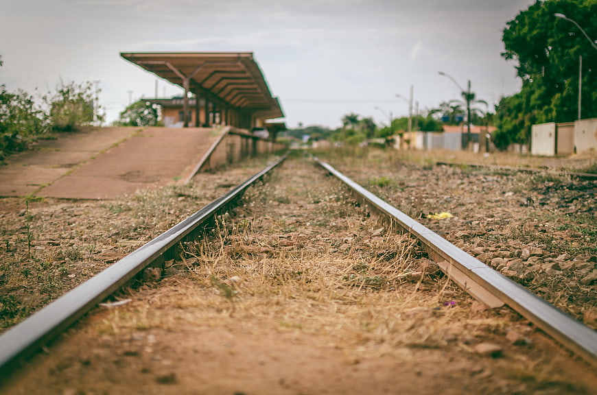 Overgrown railway tracks at an abandoned train station