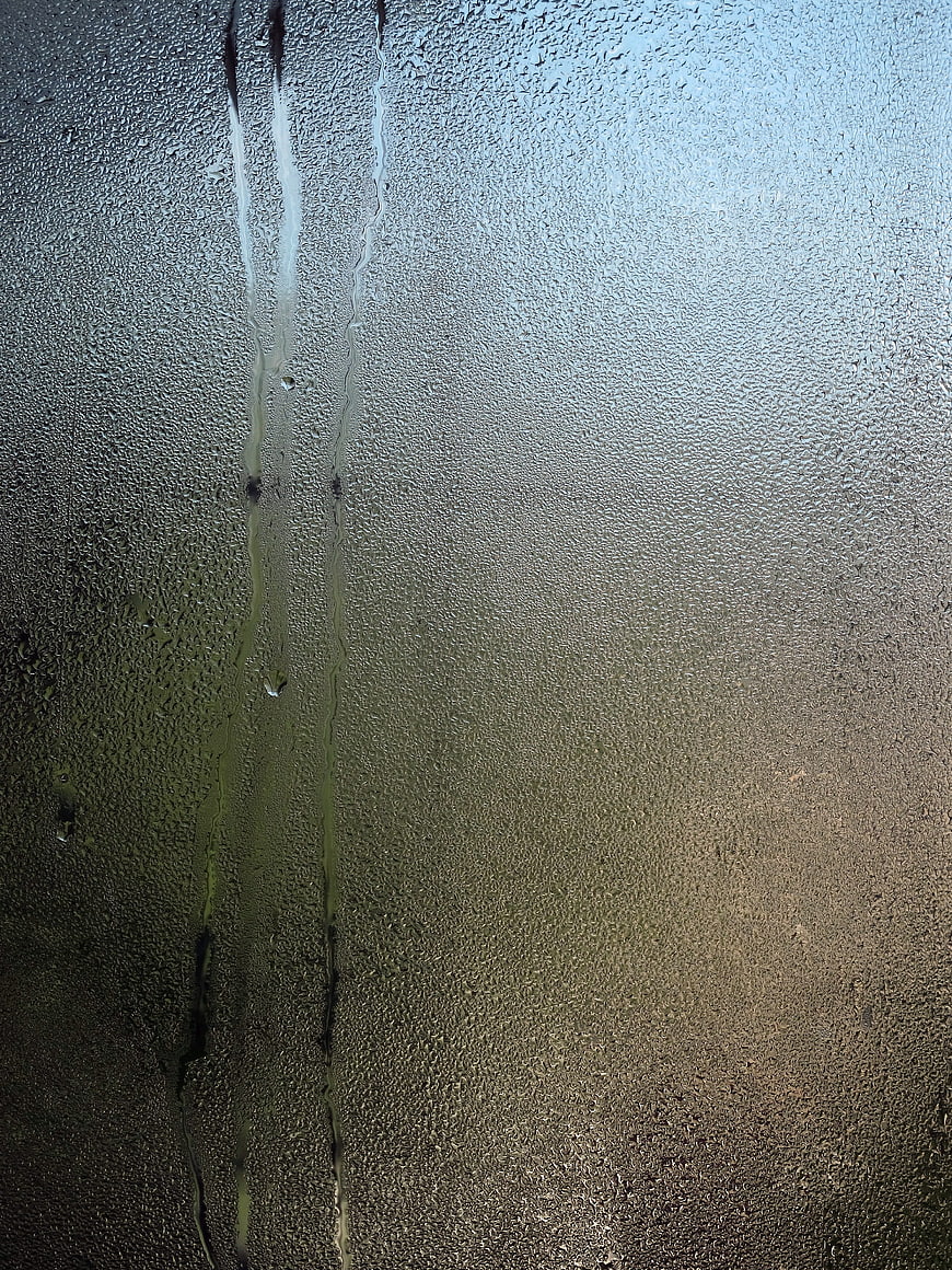 Condensation droplets on a glass window pane texture