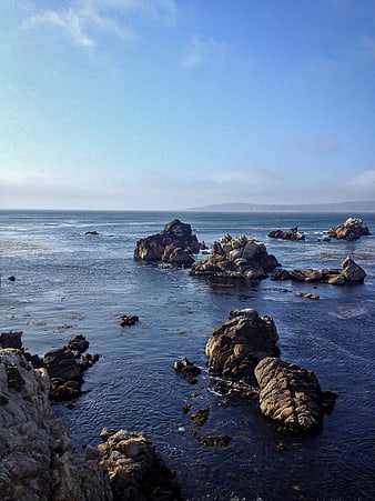 Rocky Pacific Coastline with Ocean Waves and Blue Sky