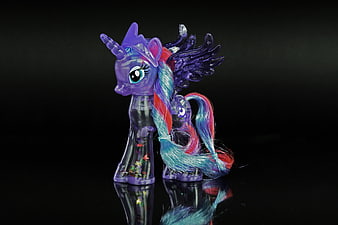 Translucent Purple Unicorn Toy Figure With Colorful Mane On Black Background