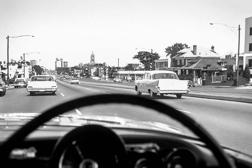 Vintage Black and White Driving View from Classic Car Dashboard