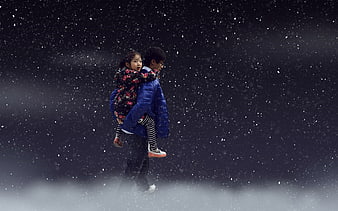 Man Carrying Girl In Snowy Night