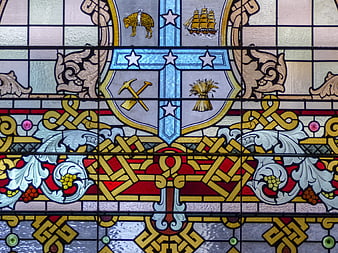 Detailed Stained Glass Window with Heraldic Shield and Celtic Knots