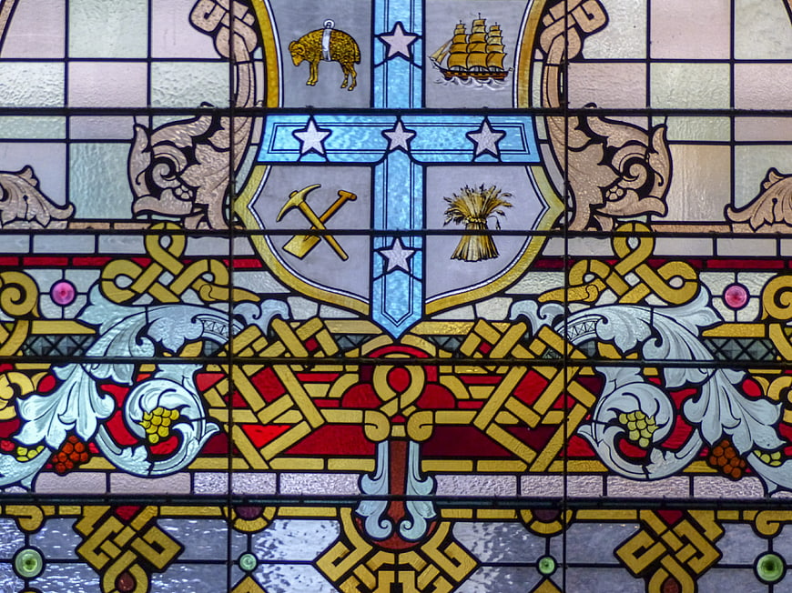 Detailed Stained Glass Window with Heraldic Shield and Celtic Knots
