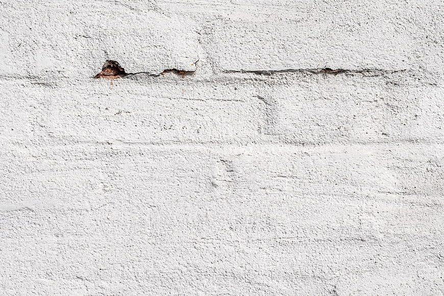 White Textured Concrete Wall Background With Cracks