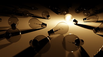 Illuminated Light Bulb Among Unlit Glass Bulbs on Reflective Surface