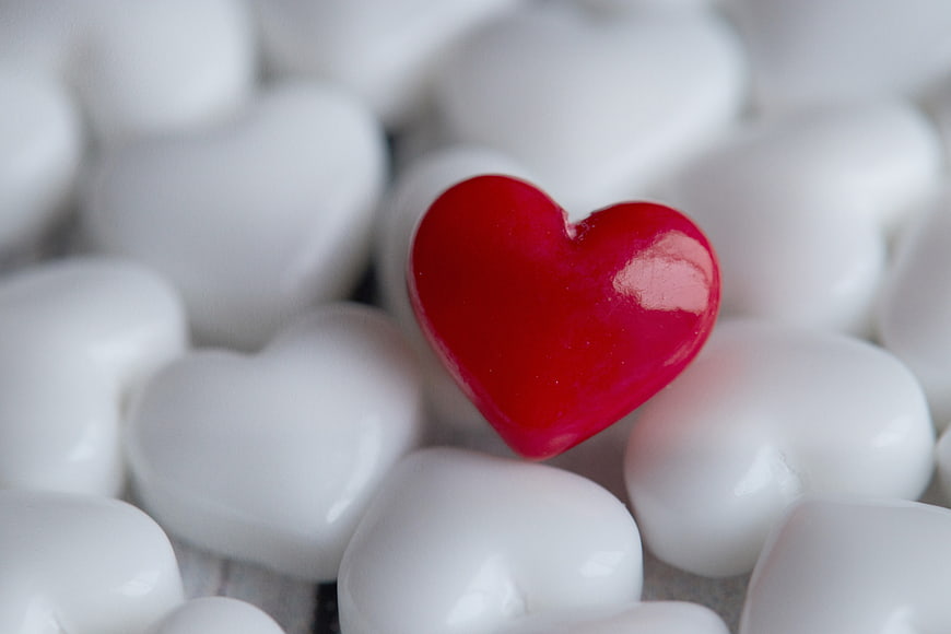 Red Heart Candy Among White Hearts Close Up