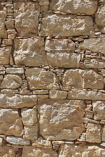 Textured beige stone wall background with natural rock pattern