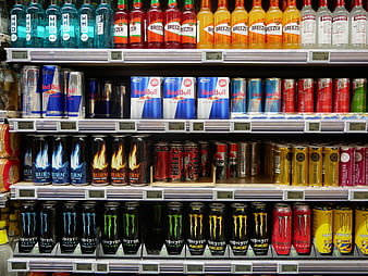 Supermarket shelf stocked with various energy drink brands and bottles