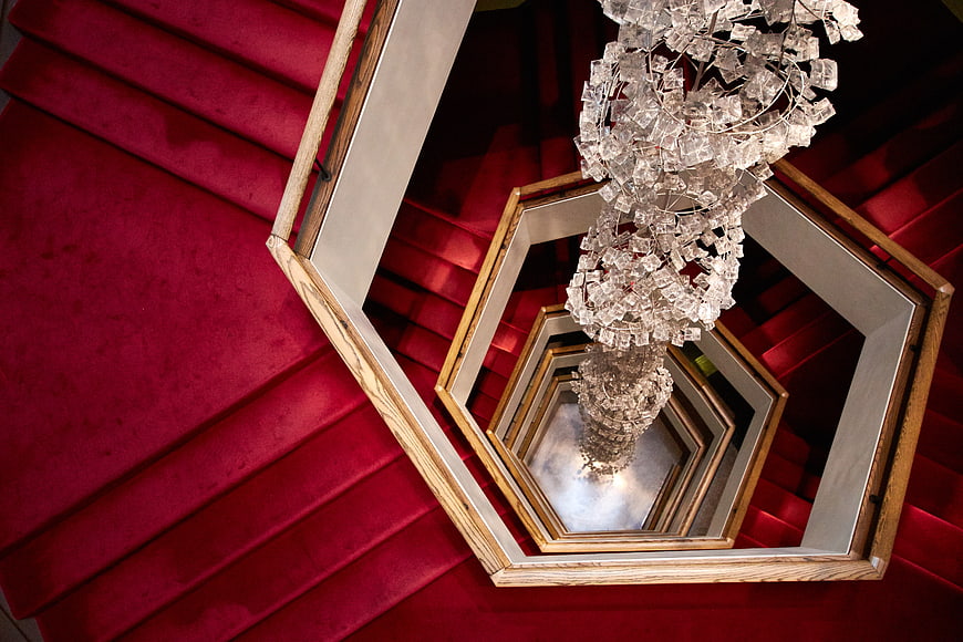 Abstract view of red spiral staircase with crystal chandelier