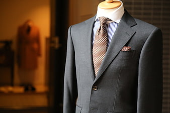Gray textured suit with polka dot tie on mannequin