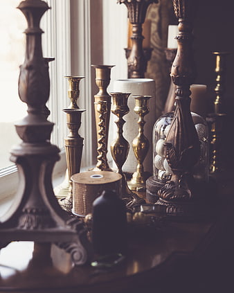 Antique Brass Candlesticks and Decorative Objects on Wooden Table