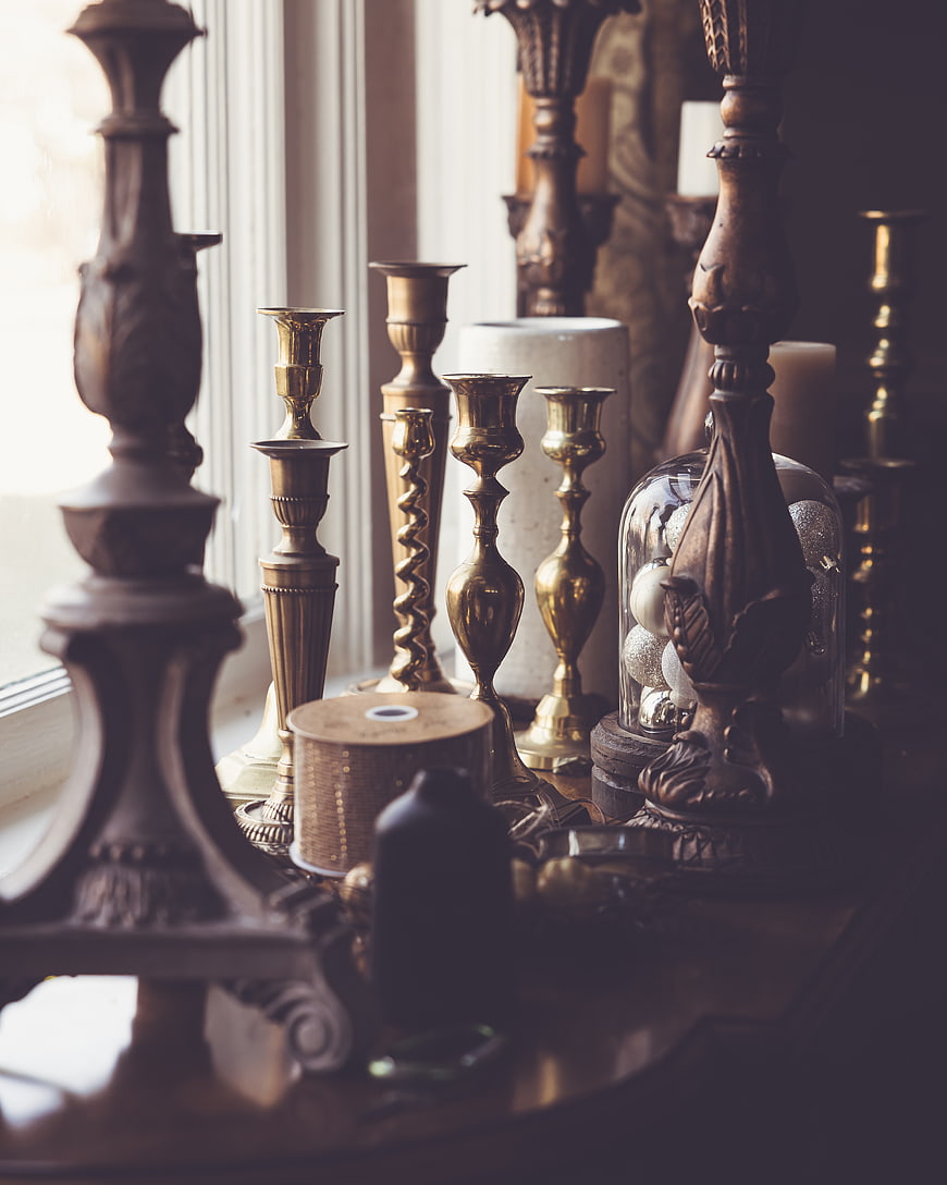 Antique Brass Candlesticks and Decorative Objects on Wooden Table