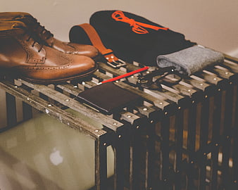 Men's fashion accessories and leather shoes on wooden crate